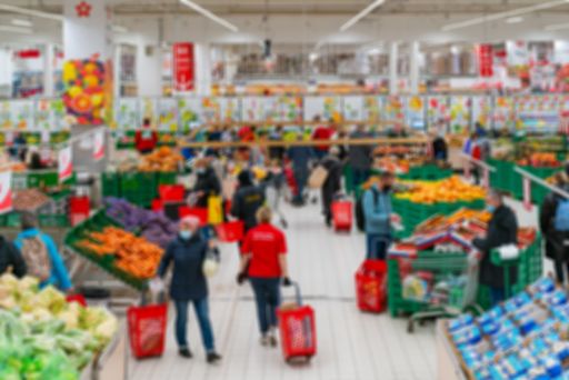 A blurred shot of people shopping in the supermarke