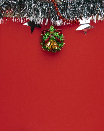 A vertical shot of beautiful Christmas decorations on red background with a copy space