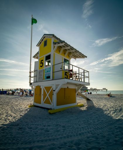 A vertical view of a lifeguard shack at a sandy beach, in Clearwater Florida