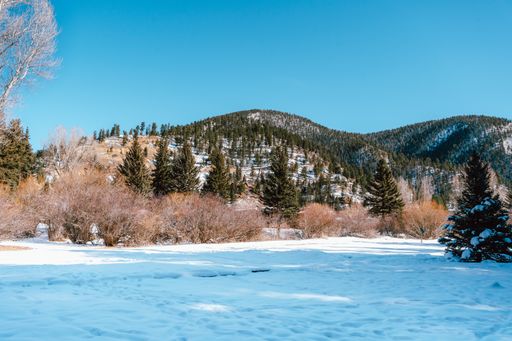 A beautiful view of the ground covered in the snow on the mountains covered in snow background