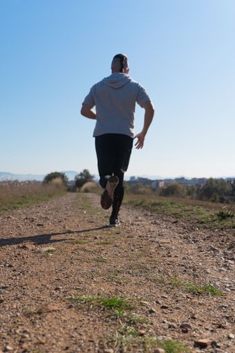 A vertical shot of an athlete exercising and working out on a warm sunny day