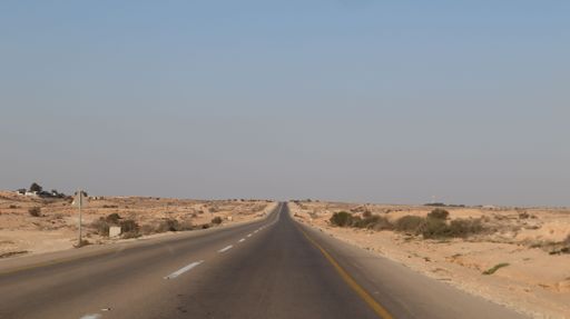 A highway road in the desert of Negev with a blue sky in the background, Israel