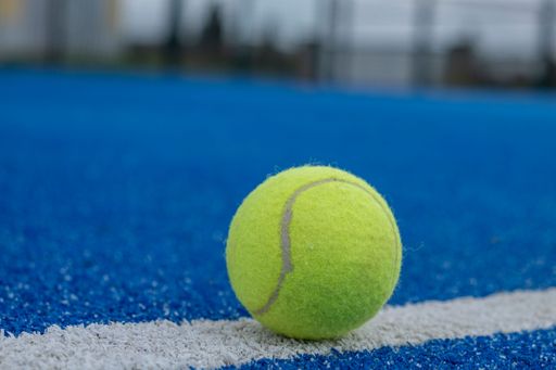 blue paddle tennis court and a ball