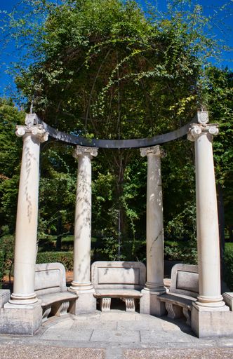 A vertical shot of the Stone seats with  columns in the gardens of the royal palace of Aranjuez, Spain