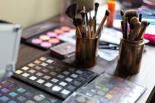 A closeup shot of a table with makeup and brushes