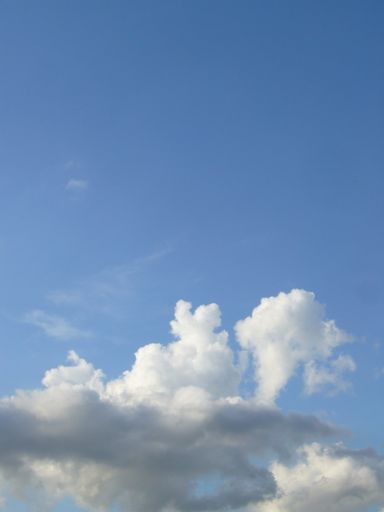 A vertical shot of beautiful cloudscape on background of the blue sky