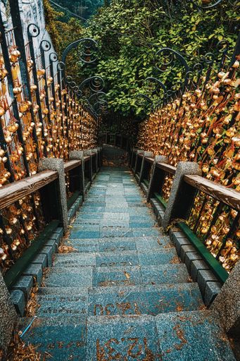 A vertical shot of a stairway going down the beautiful decorated railings