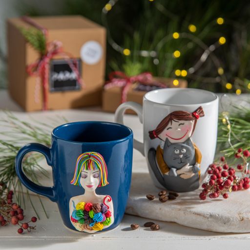 A closeup of colorful mugs on the table with Christmas decorations on it