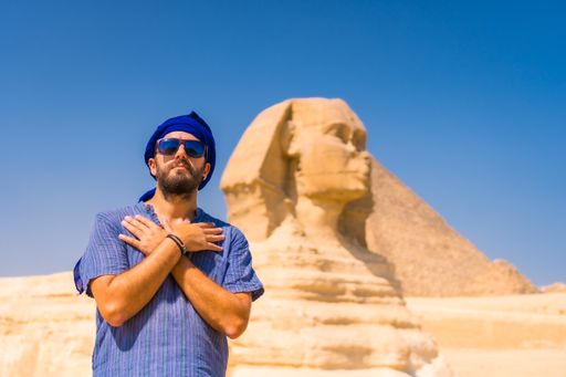 A young tourist wearing a blue turban standing near the Great Sphinx of Giza, Cairo, Egypt