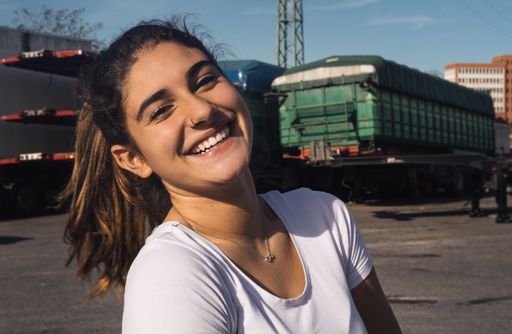 A selective focus shot of a cute attractive female holding a telephone and laughing