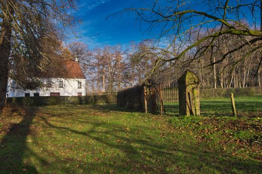 An old countryside house with a backyard and damaged fence, autumn nature of Maransart in Lasne, Belgium