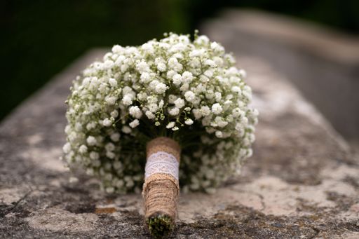 A closeup shot of a beautiful white wedding bouquet on the blurred background