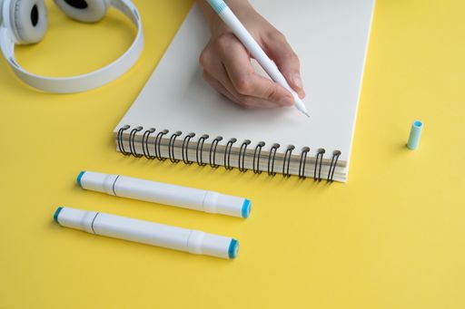 A closeup shot of a student writing on a notepad