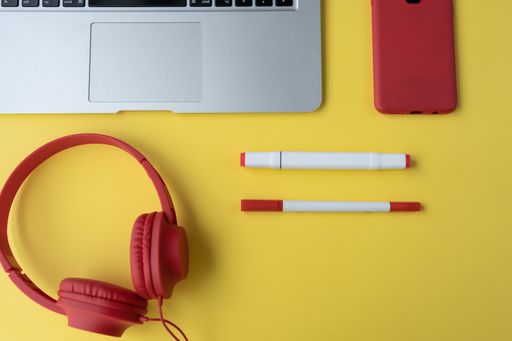 A top view of a students desk with headphones and a laptop