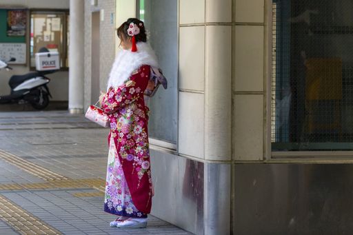 January 13, 2020, Tokyo, Japan - A Japanese girl dressed in a colorful kimono is seen on the street during the Coming of Age Day celebration.