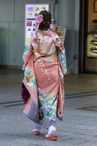 January 13, 2020, Tokyo, Japan - A Japanese girl dressed in a colorful kimono is seen on the street during the Coming of Age Day celebration.