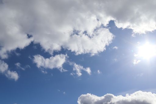 A beautiful shot of the cloudscapes and the bright sunbeams in a blue sky