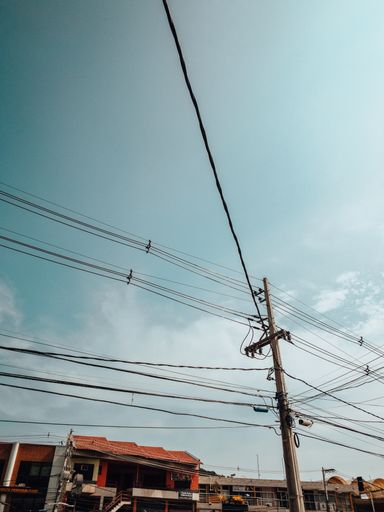 A vertical shot of electric wires on the pole