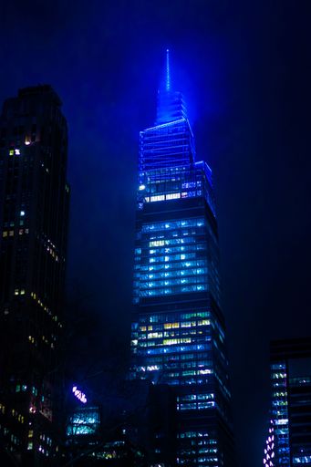 A vertical night shot of illuminated summit one Vanderbilt tower in New York City, USA