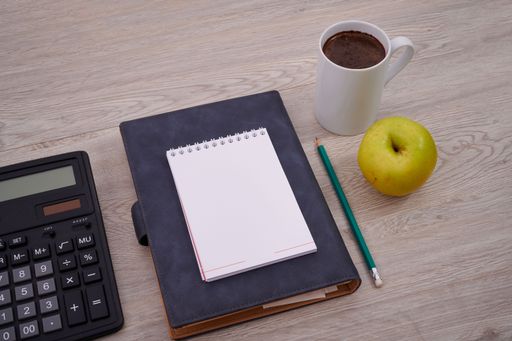 Blank Notebook Page With A Calculator And Geometric Stationery. Empty Lined Notepad With Calculation Compass Office Supplies Over Desk.