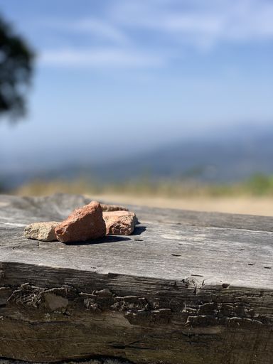 A vertical closeup shot of rocks on a wooden surfa