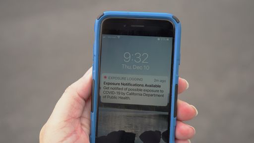 Close up of a smartphone in a person's hand, displaying the new California Covid-19 Exposure notification app