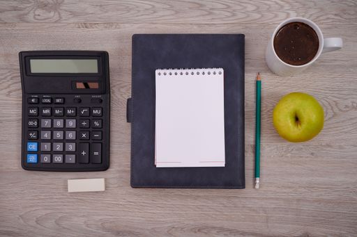 Blank Notebook Page With A Calculator And Geometric Stationery. Empty Lined Notepad With Calculation Compass Office Supplies Over Desk.