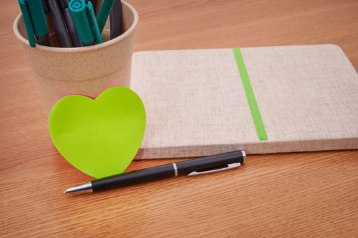 Plain Blank Open Notebooks With Stack Of Pens Inside Container On Top Of Table. Simple Empty Lined Notepads Beside Holder Of Ballpens On Desk.