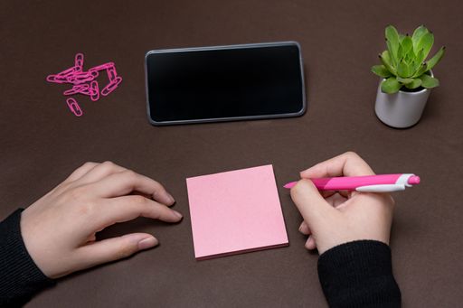 Woman Holding Blank Notes Writing Messege Updates Next To Mobile. Lady Palm Showing Envelope Folding Sending Letters Post Address And Email Phone.