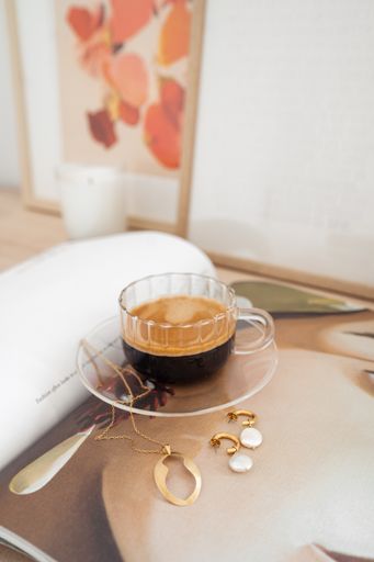 A vertical shot of a cup of espresso coffee drink on the table