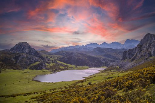 A mesmerizing view of the Lake Ercina gleaming under the pink cloudy sky in  Asturias, Spain
