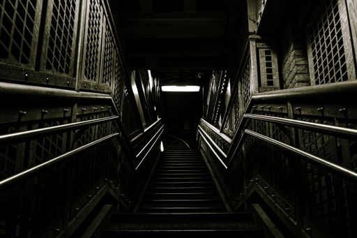 A dark metallic staircase under the lights in a building in Chicago