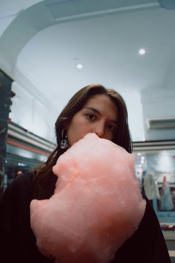 A vertical shot of a girl with candy cotton