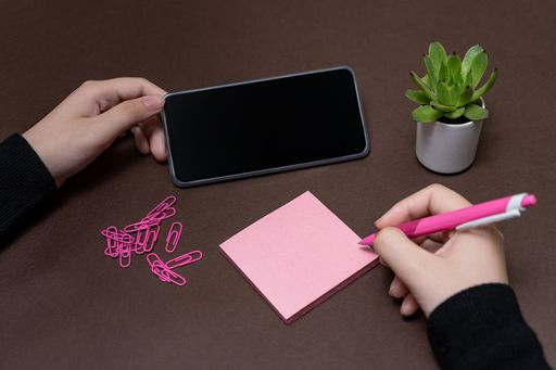 Woman Holding Blank Notes Writing Messege Updates Next To Mobile. Lady Palm Showing Envelope Folding Sending Letters Post Address And Email Phone.