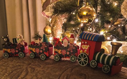 A closeup of the toy train under the Christmas tree
