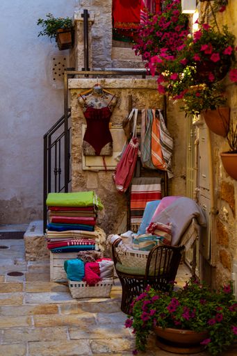 A vertical shot of various colorful fabrics displayed at a s