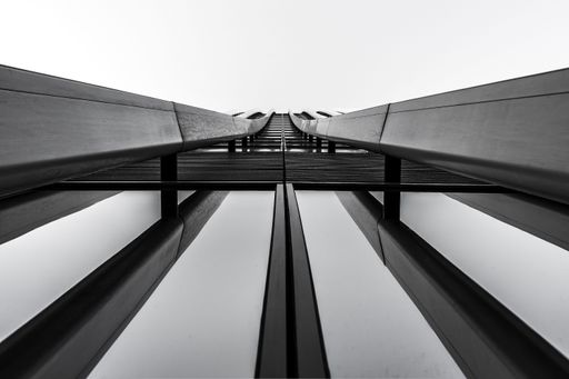 A greyscale of modern architecture under the lights - a cool picture for backgrounds and wallpapers
