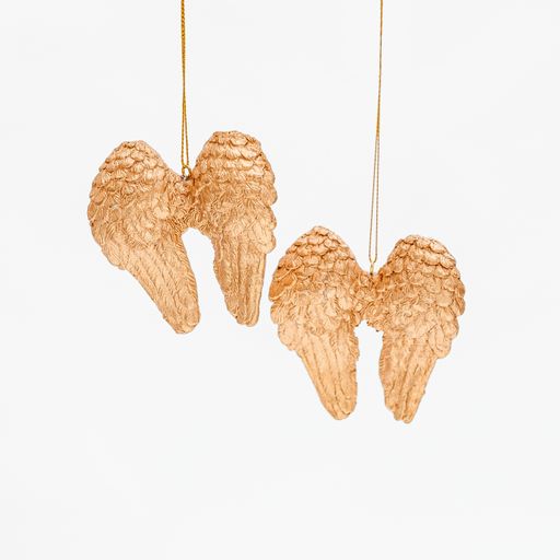 A vertical shot of wing-shaped golden Christmas tree toys isolated on a white background