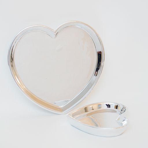 A vertical shot of heart-shaped plates isolated on a white ba