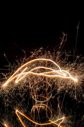 A vertical shot of abstract goldsparkles in the dark with space for text