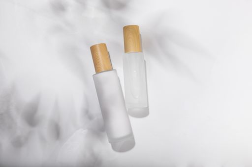 A top view of small glass bottles for cosmetic skincare products