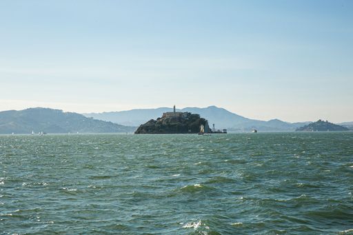 A mesmerizing shot of Alcatraz Island and the old prison, the mountains in the background