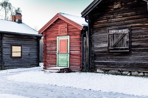 An old wooden brick homes in the center of a snow-covered residential area