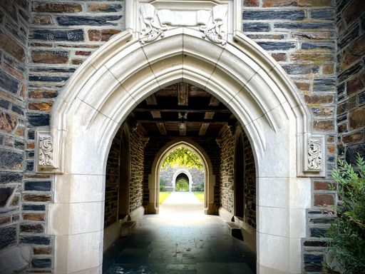 Open passage in an arched and aligned stone building. the Building forms part of the student dormitories at Duke University in Durham