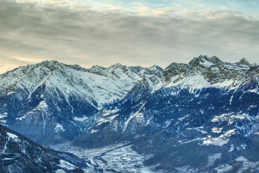 A view of the peak of Cima di Tel mountains against a cloudy sky in Merano, Italy