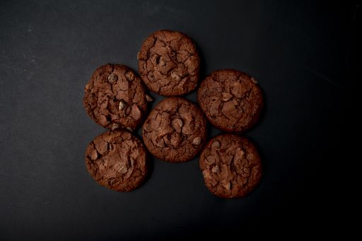 A top view of chocolate brownie cookies on a black background