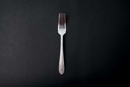 A top view of the fork on a black background