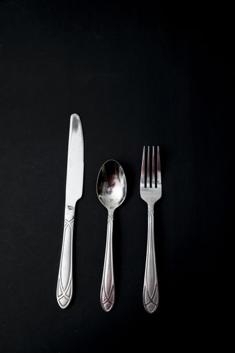 A vertical shot of knife, spoon, and fork