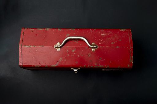 A top view of a red metal vintage suitcase