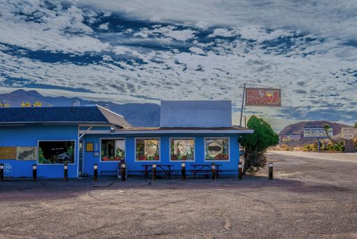 A scene of the Ghost Town with an old blue cafe during the daytime in Death Valley, Beatty, Nevada, USA